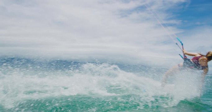Beautiful young woman kitesurfing