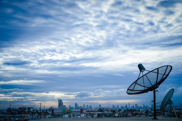 Satellite dish antenna on top of the building in urban area