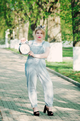 Girl with a clock (alarm clock) in her hands. Time management. The concept.