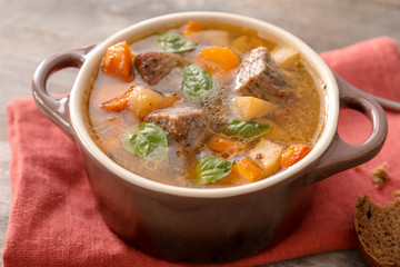 Casserole with tasty meat and potatoes on table