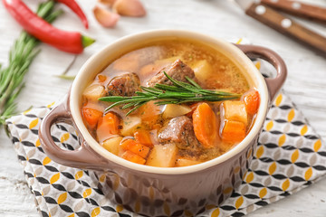 Casserole with tasty meat and potatoes on table