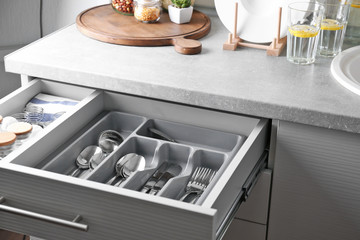 Set of cutlery in kitchen drawer