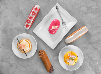 Composition with tasty cakes on grey background, top view