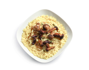 Plate with tasty risotto and mushrooms on white background