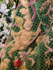 Detail of an angel embroidered on the green mantle of the brotherhood of Macarena, in the Holy Week of Seville, Spain