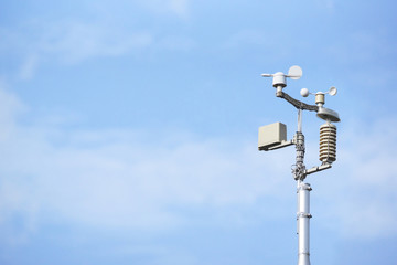Weather station on blue sky background
