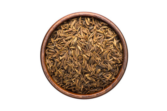 zira black spice in wooden bowl, isolated on white background. Seasoning top view
