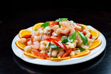 Chinese cuisine. Colorful stir fry in a wok. Shrimps with vegetables