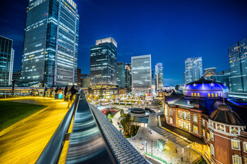 Obraz na płótnie Canvas Asia Business concept for real estate and corporate construction - panoramic urban city skyline aerial view and tokyo station under twilight sky and neon night in tokyo, Japan