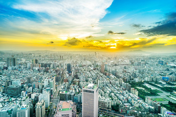 Asia Business concept for real estate and corporate construction - panoramic urban city skyline aerial view under twilight sky and golden sun in Taipei, Taiwan