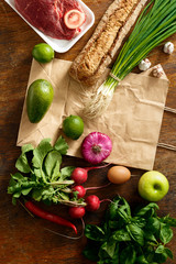 Paper bag set healthy food wooden table top view