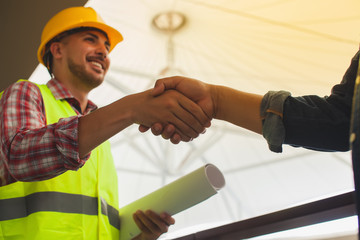 Engineers celebrating success, clapping with hands.Teamwork conceptual image.Engineer's shaking...