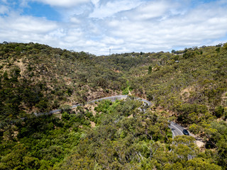 Fototapeta na wymiar aerial view of road winding through australian forest