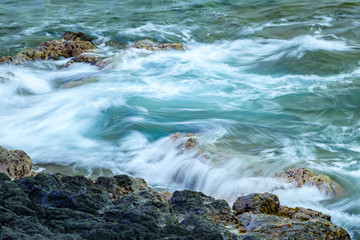 Blurred water with a slow shutter speed, lava shoreline of the Pacific Ocean, Hawaii
