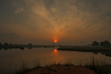 Sunrise over the river with reflection