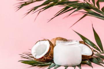 Coconut oil and coconuts on a bright pastel background. - obrazy, fototapety, plakaty