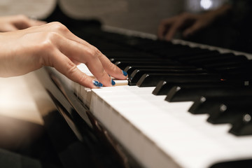 Fototapeta na wymiar women hand on classic Piano keyboard closeup