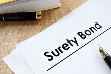 Surety bond form and pen on a table.