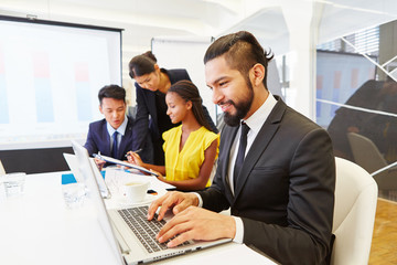 Businessman writing on laptop