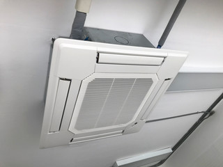 Ceiling type 4 directions air vent system hanging air conditioner unit in a modern office building