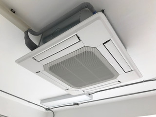 Ceiling type 4 directions air vent system hanging air conditioner unit in a modern office building