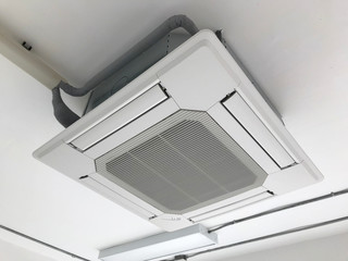 Ceiling type 4 directions air vent system hanging air conditioner unit in a modern office building