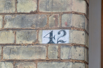 House number 42 sign painted on wall