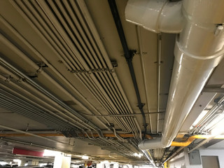 Underground piping service system in an office building car parking delivering fresh water, sewage,...