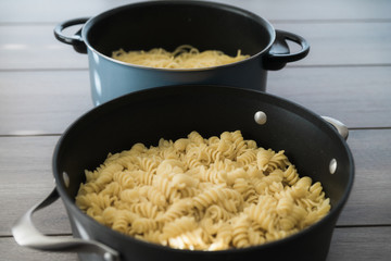 Pot of Freshly cooked Pasta Spaghetti on white wood table 