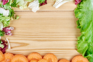 Frame of fresh vegetables on wooden background. Healthy natural food on table with copy space . Cooking ingredients top view, mockup for recipe or menu.