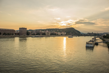 Naklejka premium waterfront city district with old building in rainy day in sunset evening time