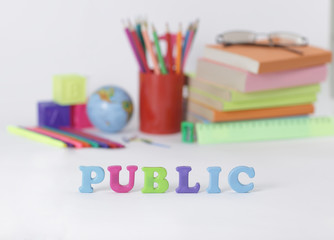 word public on blurred background of school supplies .photo with copy space