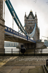 Low angle view of the Tower bridge, London with lifebuoy in the foreground. The bascule and suspension bridge crosses the River Thames and has become an iconic symbol of London. © Lena Maximova
