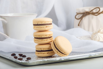 Coffee macarons with chocolate. French delicate dessert for Breakfast