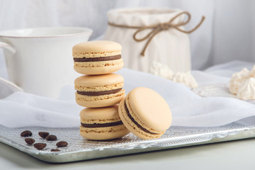 Coffee macarons with chocolate. French delicate dessert for Breakfast