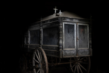 Old abandoned and dusty hearse carriage