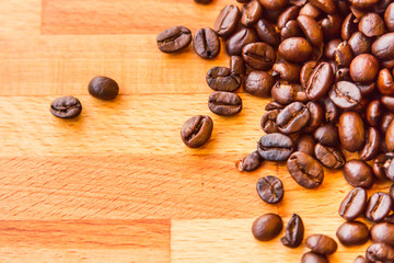 Roasted coffee beans on wooden floor