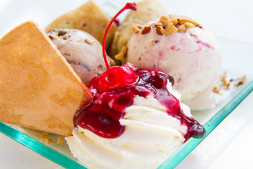 A sweet and tasty ice cream with whipped cream and sauce