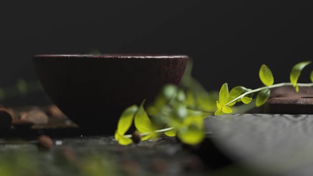 Close up of elegant old kitchen table with fresh basil and wooden bowl.