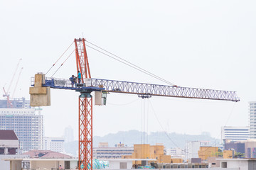 Fototapeta na wymiar Construction crane, building construction using modern machinery