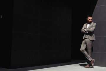 Smartly dressed businessman, Modern businessman. Confident young man in full suit standing outdoors...