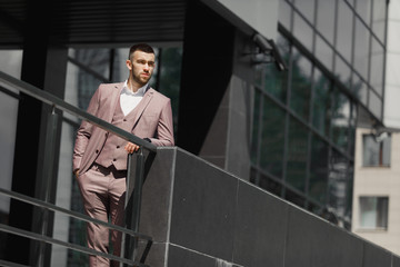 Businessman in city. Modern businessman. Confident young man in full suit standing outdoors