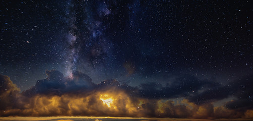 Panorama of the starry sky over the red horizon