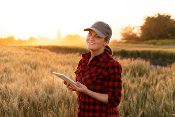 A woman farmer with tablet. Smart farming and digital agriculture.