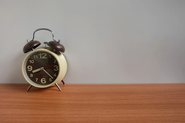 Alarm clock on wooden floor and White background with copy space, Morning wake up for the new day...