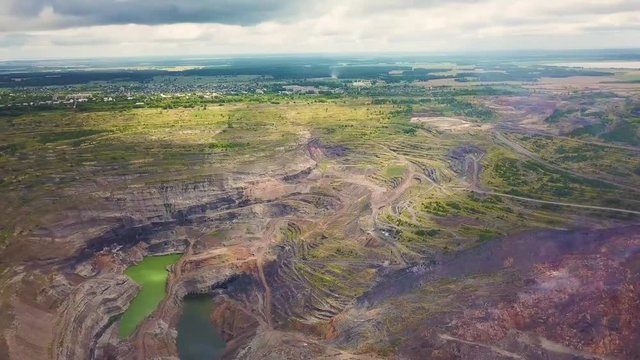 Super high flight with a drone over a crater created by mining works