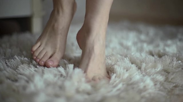 Beautiful young girl bare feet moving on interior in the living room in slow motion.