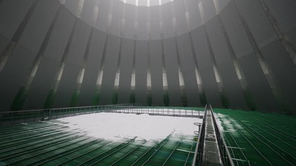 bridge over green pools in large cooling tower