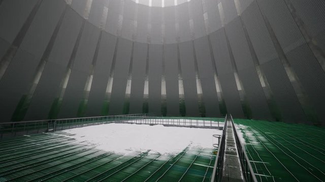 bridge over green pools in large cooling tower