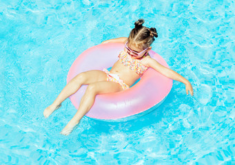 Cute and funny girl in swimming pool